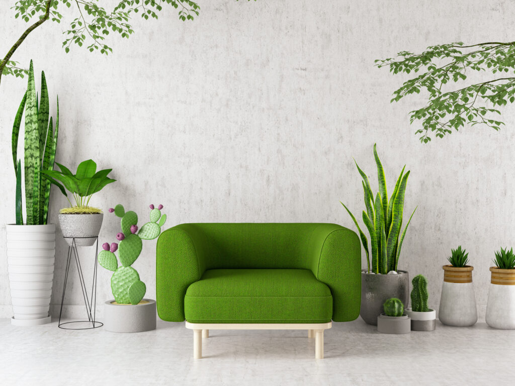Modern interieur met een groene designstoel, omringd door kamerplanten en een lichte achtergrond – een frisse woontrend voor de lente van 2025.