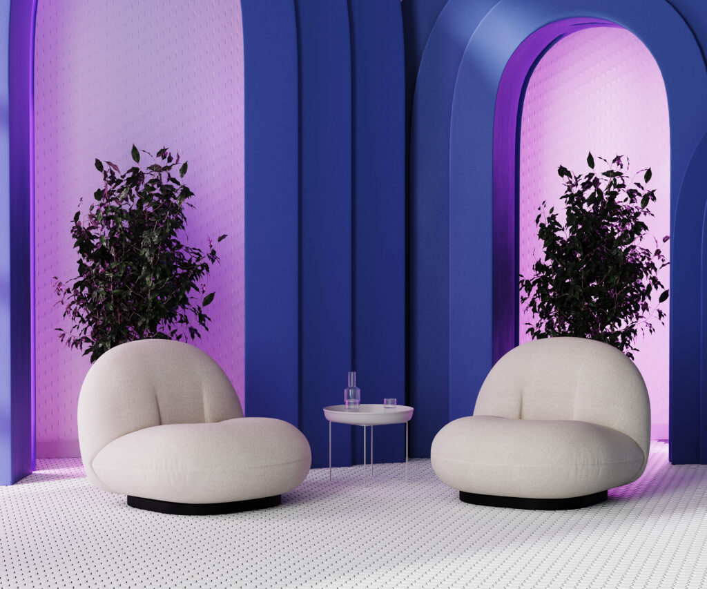 Moderne zithoek met ronde stoelen en opvallende blauwe wandpanelen – inspiratie voor kleurzones en trendkleur Electric Blue in 2025